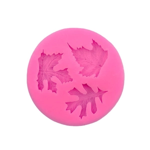 Pink circular silicone mold featuring three distinct leaf patterns for cake decoration