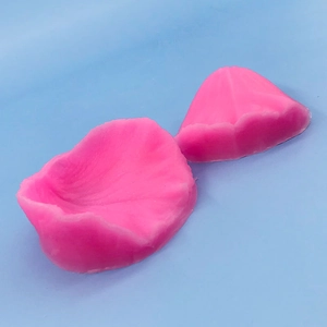Macro detail of two pink silicone molds showing realistic petal textures for fondant cake