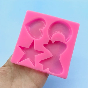 Pink silicone mold featuring star, moon, heart, and bow shapes for DIY cake decorating