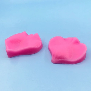 Detailed view of pink rose petal silicone molds for fondant cake and soap making