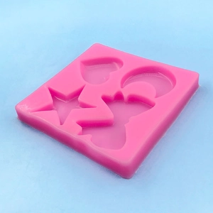 Pink silicone DIY mold with heart, star, moon and rabbit shapes on blue background