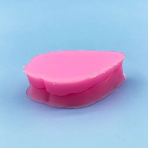 Pink leaf petal silicone mold for fondant and baking decoration on blue background