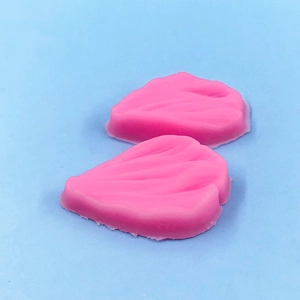 Detail of pink silicone petal molds with realistic leaf vein texture for fondant baking