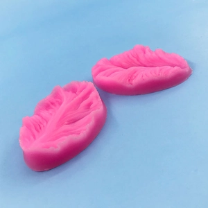 Detail of pink silicone leaf mold with intricate vein textures for fondant decorating