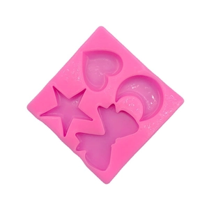 Pink silicone DIY mold with star, heart, moon and bow shapes for cake decorating