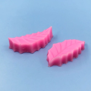 Detailed view of pink silicone leaf mold with realistic vein textures for baking fondant
