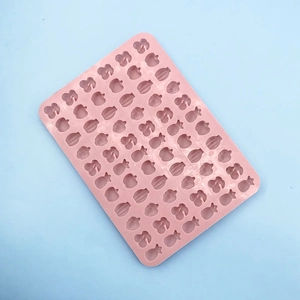 Pink silicone mold featuring various fruit shapes like apples, pineapples, and grapes