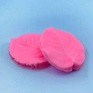 Pink silicone leaf mold for fondant cake decorating with detailed leaf vein texture