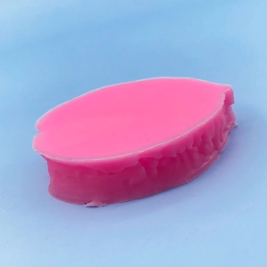 Pink leaf-shaped silicone mold with ribbed texture for fondant baking and cake decoration