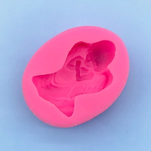 Detailed macro view of a 3D angel baby embossed design inside a pink silicone mold