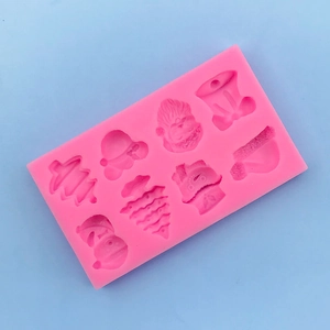 Detail of 8-cavity pink silicone mold featuring Christmas tree, Santa, and snowman shapes