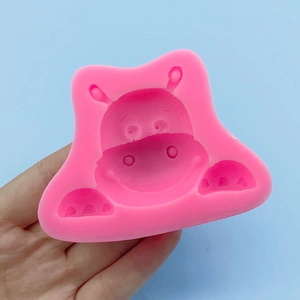 Pink silicone hippopotamus mold for cakes, chocolate, and DIY crafts held in hand