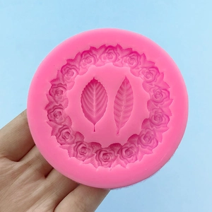Pink silicone round mold featuring detailed rose garland and leaves for DIY crafts