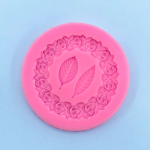 Detail of pink silicone mold with rose wreath and leaves pattern for cake decorating