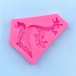 Macro view of pink silicone mold with intricate coral and wave texture for DIY craft