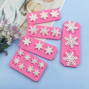 Pink silicone snowflake molds for Christmas cake baking and chocolate decorations