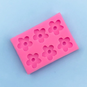 Detail view of 6-cavity pink silicone mold for flower-shaped chocolate and DIY crafts