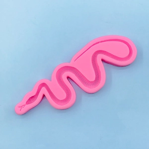 Detail of pink silicone mold showing intricate snake scale texture for DIY baking