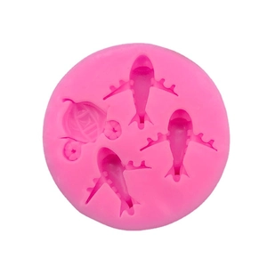 Pink round silicone mold featuring airplane and carriage shapes for DIY cake decorating