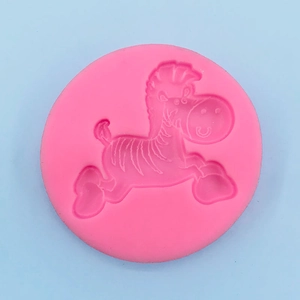 Detailed macro view of a pink silicone mold with a cartoon zebra relief for cake baking