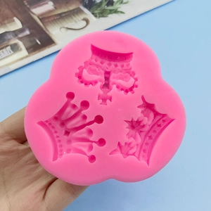 Pink silicone crown mold featuring three distinct tiara designs for cake decoration
