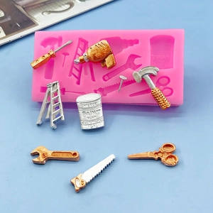 Silicone tool mold for fondant featuring hammer, saw, and ladder shapes with metallic finishes