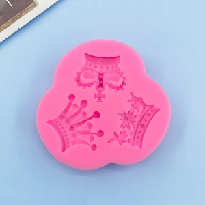 Detailed pink silicone mold featuring three distinct crown shapes for cake decoration