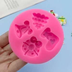 Pink silicone mold with Christmas tree and bell shapes for chocolate DIY baking