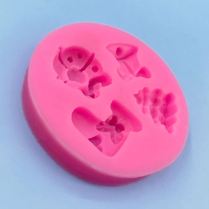 Pink silicone mold with Christmas sock and bell shapes for fondant and baking decoration
