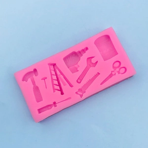 Flat lay of pink silicone mold featuring 8 distinct hardware tool shapes for fondant diy