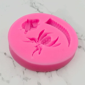 Pink silicone mold with spider, moon, and floral designs for Halloween cake decoration