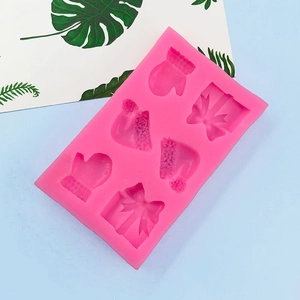 Pink silicone mold featuring glove, hat, and gift box shapes for Christmas baking