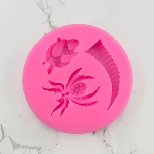 Detailed view of pink silicone mold with spider, rosebud, and textured strip shapes