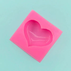 Macro view of pink heart silicone mold for handmade soap and DIY candle making projects