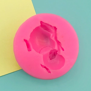 Macro view of bright pink silicone mold with 3D pomegranate cavity for fondant