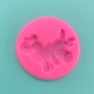 Macro shot of pink silicone mold with detailed cartoon donkey relief for baking DIY