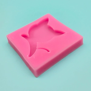 Pink silicone mold featuring a bird shaped cavity for DIY fondant and chocolate crafts