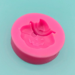 Pink silicone mold featuring Halloween pumpkin with wizard hat design for DIY baking and crafts