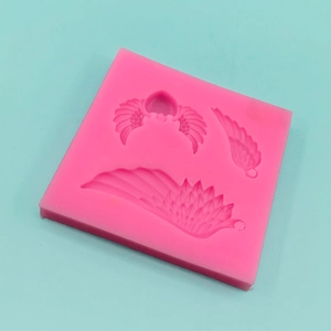Pink silicone mold featuring angel wing designs for DIY cake fondant and chocolate making
