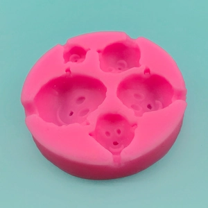 Pink silicone mold with four clown face cavities for fondant, cake and DIY chocolate making