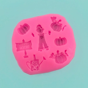 Pink silicone mold with pumpkin, scarecrow, and pumpkin patch sign for DIY baking
