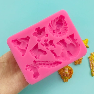 Pink silicone mold featuring animal shapes like lions and dragons for DIY chocolate making