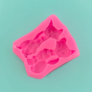 Detailed macro view of pink silicone mold with two cute fox shaped cavities for fondant