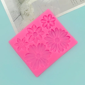 Detail view of pink silicone daisy mold with various flower sizes for cake decorating