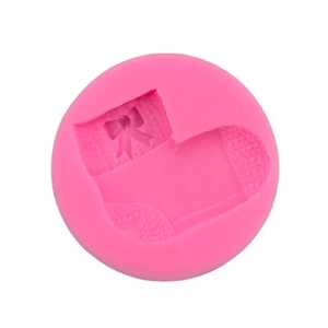 Pink silicone Christmas stocking mold with knit texture and bow for DIY baking decoration