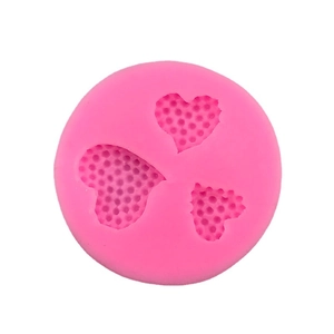 Pink round silicone mold featuring three heart shapes and honeycomb texture for baking