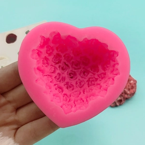 Pink heart-shaped silicone mold with rose flower texture for baking and cake decorating