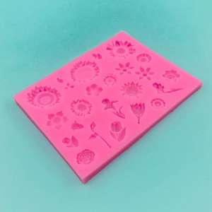 Moule en silicone rose avec divers motifs floraux comme des tulipes et des tournesols
