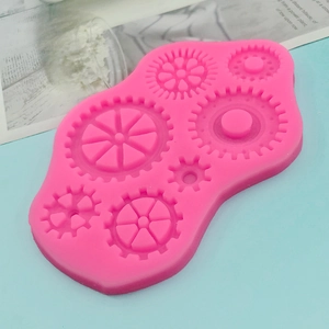 Pink silicone gear mold for DIY fondant and chocolate making on blue background