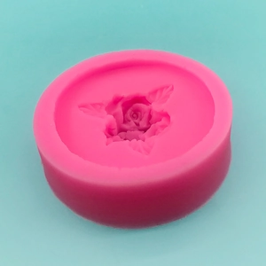 Pink silicone mold featuring three detailed rose flowers with leaves for DIY baking